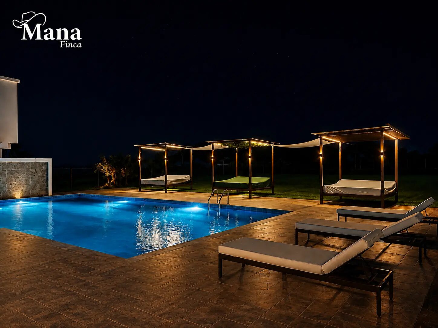 Zona de piscina de Finca Mana iluminada de noche